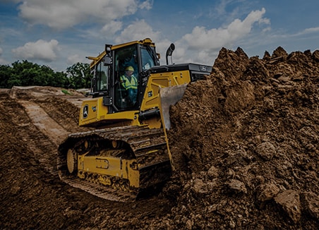The words â€œsite developmentâ€ are on top of a John Deere 750 P-Tier SmartGrade Dozer pushing dirt to prepare the site.